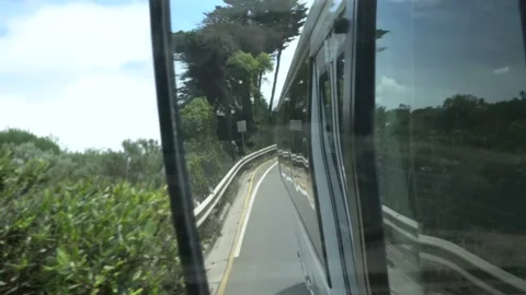 Bus Driving Through Greenery with View of Mirror Stock Footage 231590092