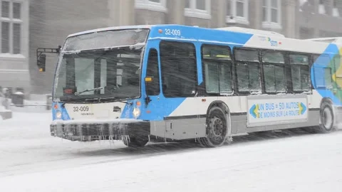 Bus driving thru heavy snowfall Stock Footage 131180267