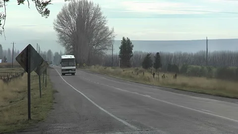 Bus Driving Toward Camera on Rural Road Stock Footage 331543913