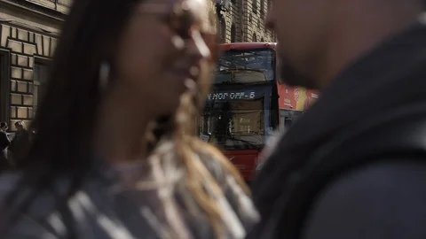 The bus going between man and woman blur (out of focus) Stock Footage 99313110