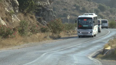 Bus On a Hillside Road Slow Motion Stock Footage 144197679