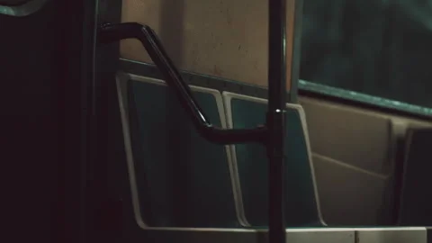 Bus interior with empty seats and metal handrail at night Stock Footage 344992353