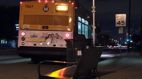 Bus leaves bus stop at night Stock Footage 47464972