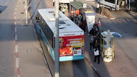 The bus leaves the stop. People in protective masks are waiting for the bus Stock Footage 165392280