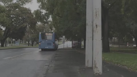 Bus leaving the bus stop Stock Footage 166090616