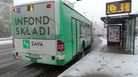 Bus leaving a bus stop in the snow in Ljubljana city center. Stock Footage 153283488