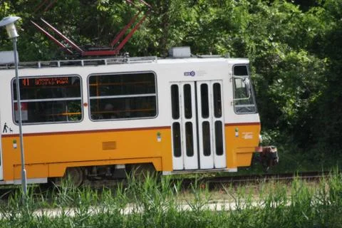 A bus that is parked on the side of a train Stock Photos