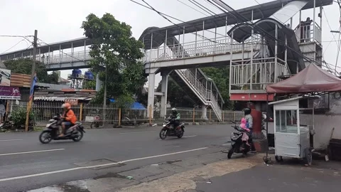 A bus passes under the pedestrian bridge Stock Footage 208674875