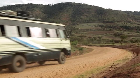 Bus passing through dirt track Stock Footage 49010409