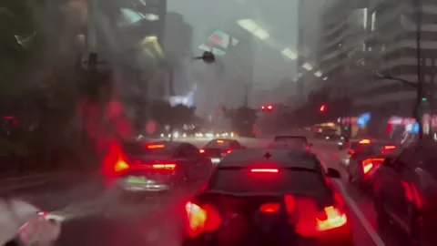 Bus POV driving through heavy rain on city street Stock Footage 338220677