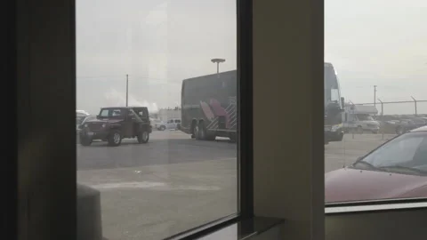 Bus Pulling Up to a Building Stock Footage 148691202