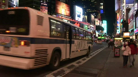 A bus pulling up to a stop in Time Square Stock Footage 593935