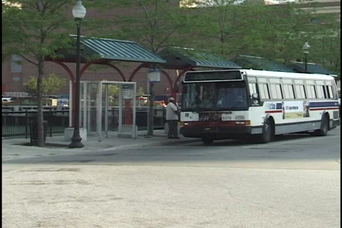 Bus Pulls Away from Bus Stop Stock Footage 296918