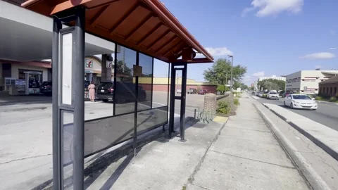 Bus stop at the 7 11 convenience store on Florida Ave Stock Footage 258089554