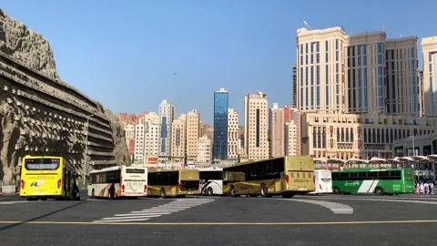 A bus stop behind the Makkah Clock Tower Stock Footage 332593518