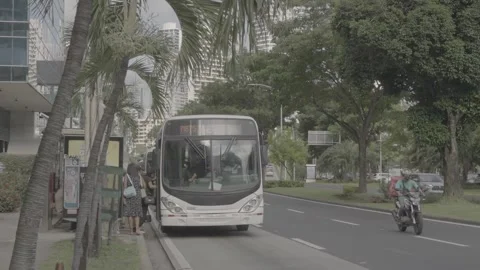 A bus stop in Panama and people boarding the bus Stock Footage 343747346