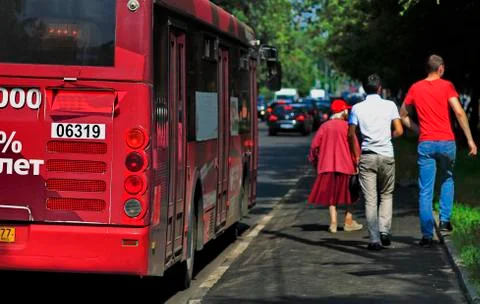 Bus stop, pedestrians Stock Photos