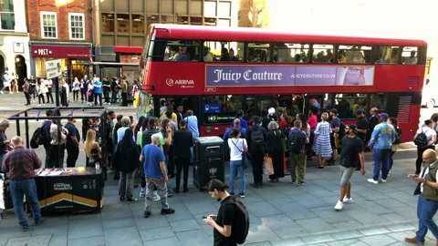 Bus stop queue, for a crammed double decker bus. London UK. Video stock 197817770
