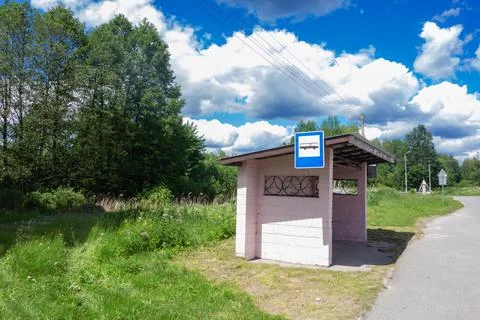 Bus stop on the side of a road in countryside Stock Photos