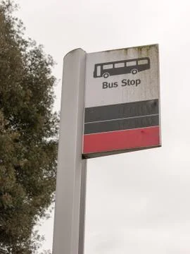 A bus stop sign with a bus vector icon white and black and red Foto stock