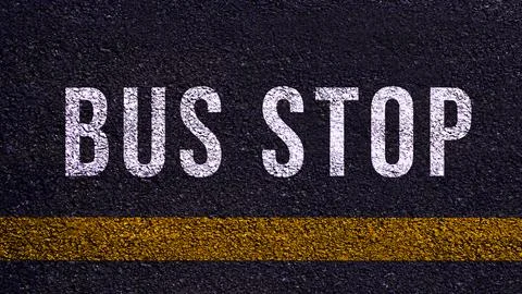 Bus stop text written and yellow line on the road in middle of the asphalt .. Stock Photos