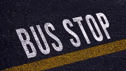 Bus stop text written and yellow line on the road in middle of the asphalt .. Stock Photos