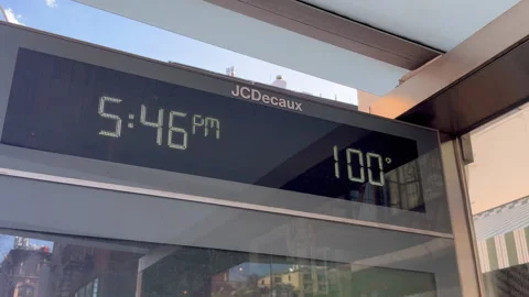 Bus stop thermometer displaying nearly 100°F during heatwave in East Village NYC 스톡 동영상 342783659