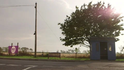 Bus stop, tree and no thanks sign on countryside Vidéo 144292216