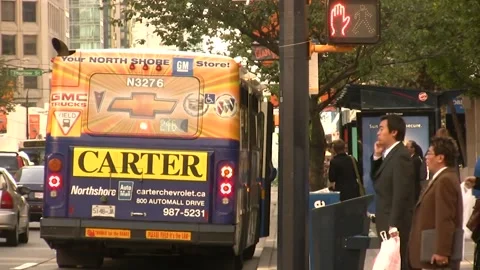 A bus stop in Vancouver with a bus waiting and pedestians Stock Footage 159908856