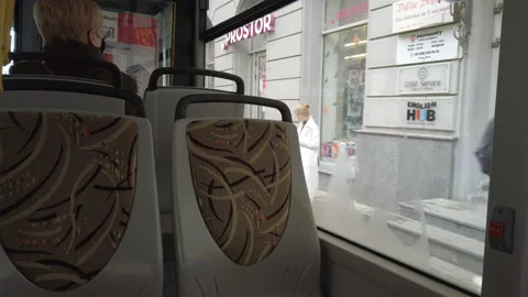 Bus stops at bus stop, people at protective face masks entering bus and taking s 库存影片 144283456