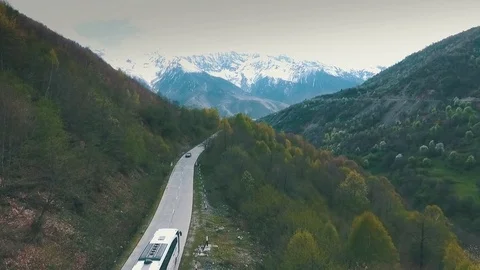 A bus traveling on a mountain road,shot from the air Stock Footage