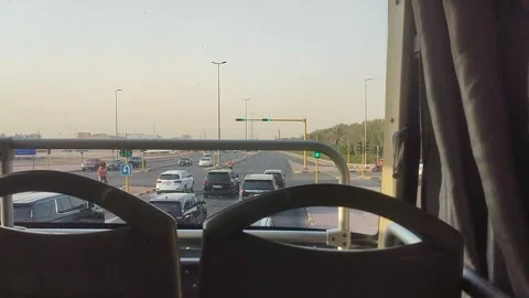Bus waiting at red light and accelerating at green signal in Ardiya, Kuwat Stock Footage 345928057