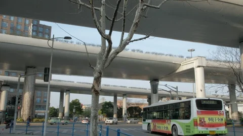 The bus waits at the crossroads under the elevated road 스톡 동영상 95836391