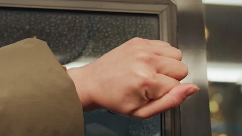 Bus window unlock. Commuter opens window latch. Person in green coat opens bus Stock Footage 337370195
