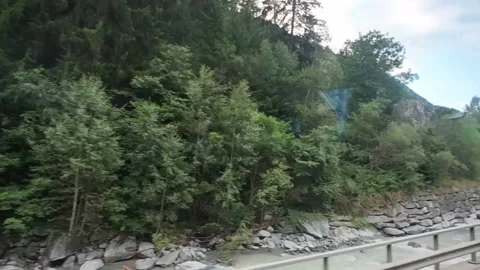Bus Window View of Alpine River and Forest Road Stock Footage 340366386