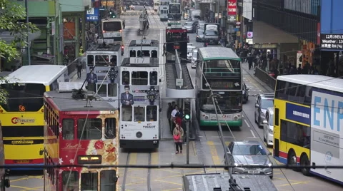Buses and pedestrians go through a crossing at a street in downtown Hong Kong Stock Footage 45407325