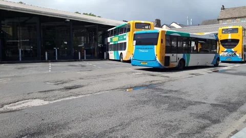 Buses arriving and leaving UK bus station Stock Footage 245219910