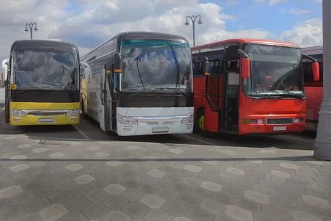 Buses on parking on the background of cloudy sky Stock Photos