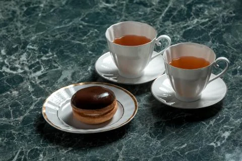 Bush cake with two white cups of black tea with saucer on marble background Stock Photos