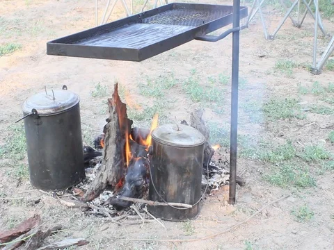 BUSH COOKING WITH CAMP FIRE Stock Footage 100417009