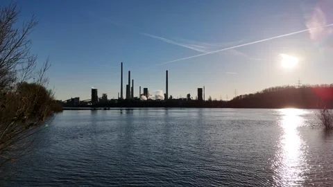 Bush framed bay with distant riverside industry Stock Footage 331204597