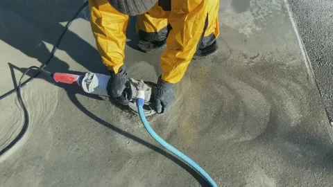 Bush-hammered finishing machine on a gray concrete floor Stock Footage 167409199