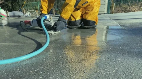 Bush-hammered finishing machine on a gray concrete floor Stock Footage 167409239