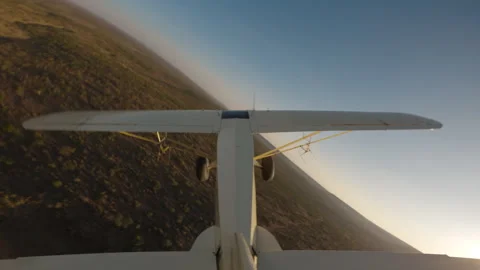 Bushcraft plane flying over a dried river bed in savannah Stock Footage 310985630