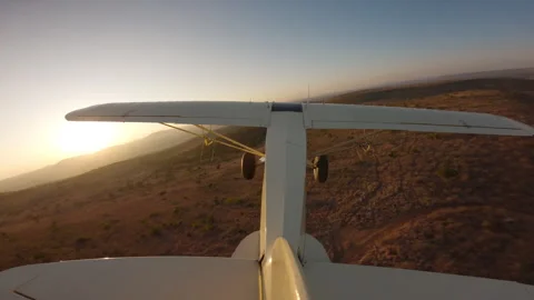 Bushcraft plane flying over hilly in savannah grassland Stock Footage 310985131