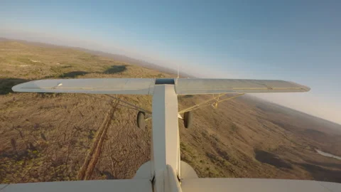 Bushcraft plane flying over plains at sunset Stock Footage 310985447