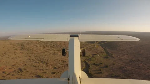 Bushcraft plane flying over a river ridge in savannah Video stock 310985645