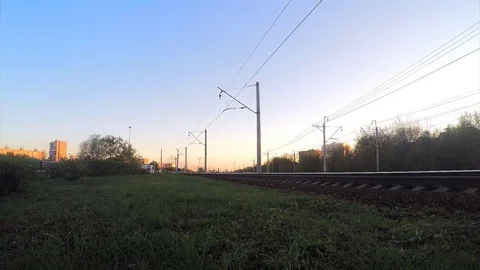Bushes and train on rails at sunset in spring timelapse 스톡 동영상 82983064
