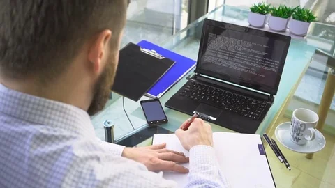 Busienessman making notes in calendar in office, close behind shot Stock Footage 73166877