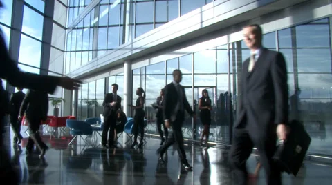 Busines partners meet and shake hands in  large contemporary corporate building. Stock Footage